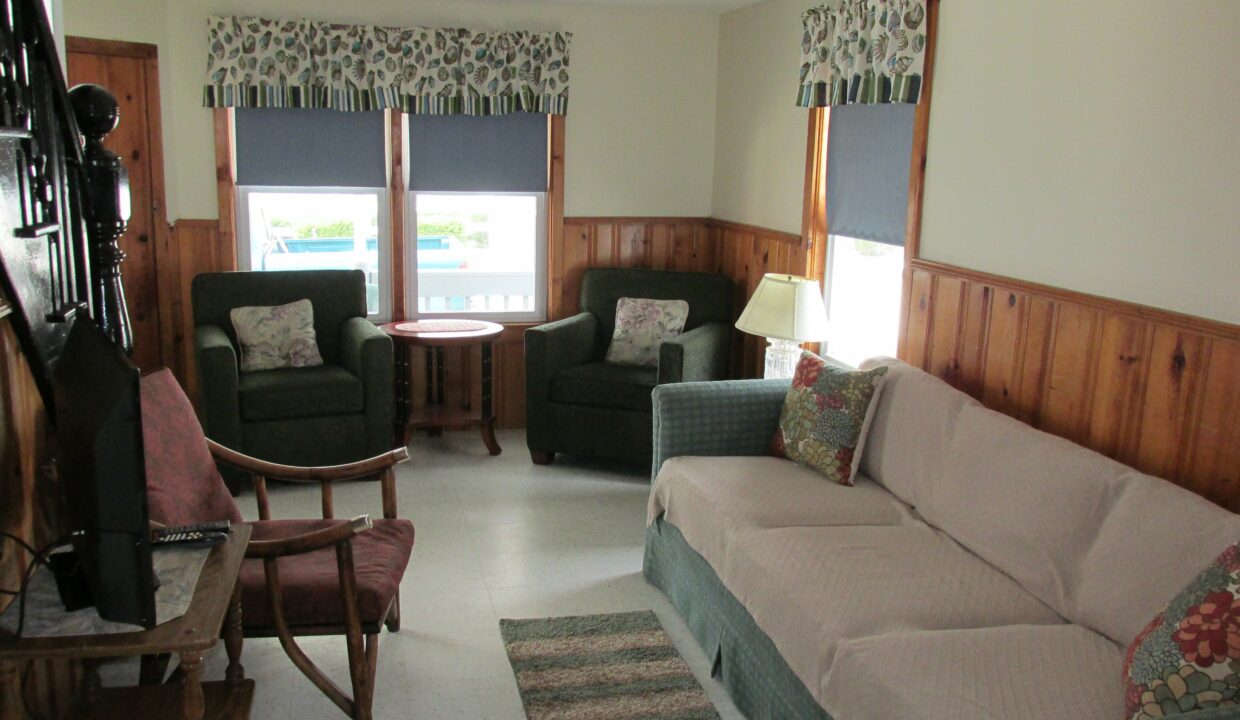 a living room filled with furniture and a flat screen tv.