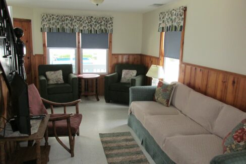 a living room filled with furniture and a flat screen tv.