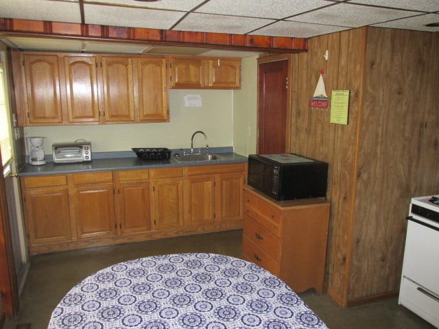 a kitchen with wooden cabinets and a blue and white table cloth.