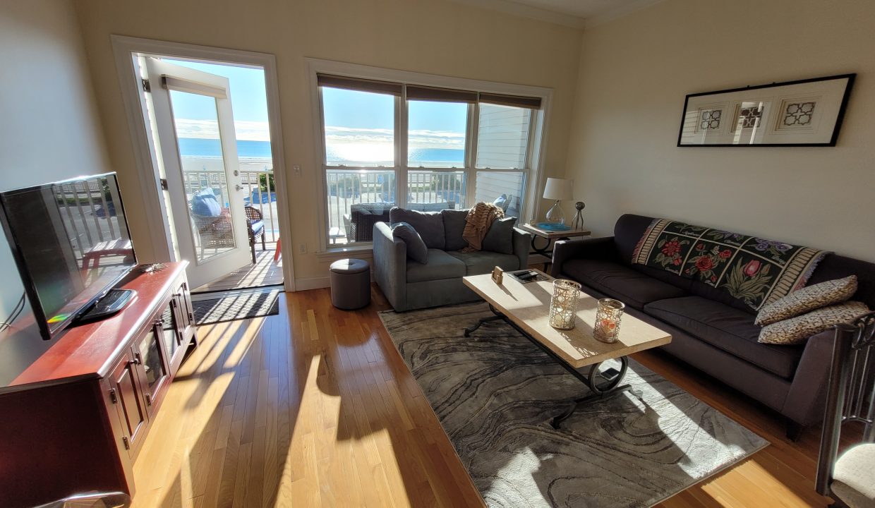 a living room filled with furniture and a flat screen tv.