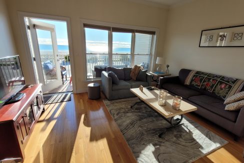 a living room filled with furniture and a flat screen tv.