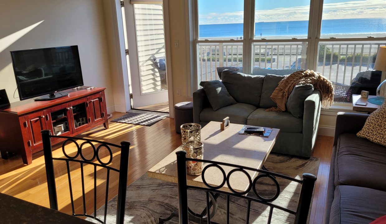 a living room filled with furniture and a flat screen tv.