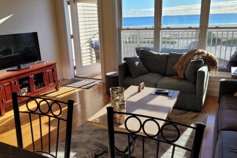 a living room filled with furniture and a flat screen tv.