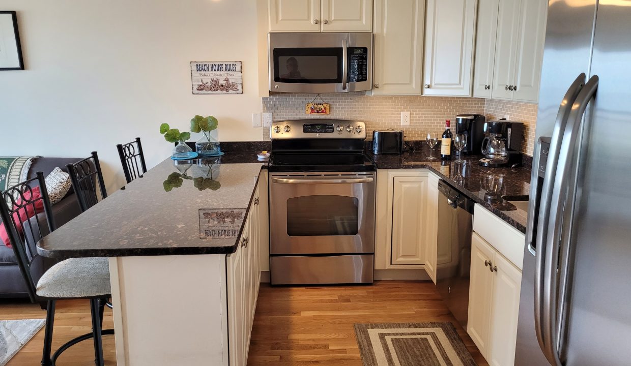 a kitchen with stainless steel appliances and white cabinets.