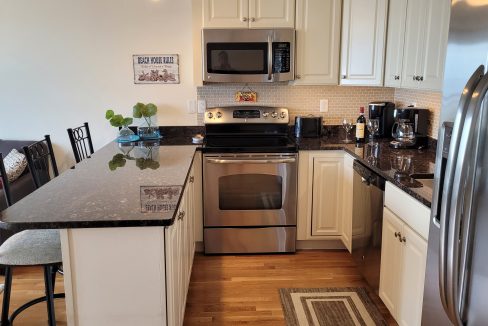 a kitchen with stainless steel appliances and white cabinets.