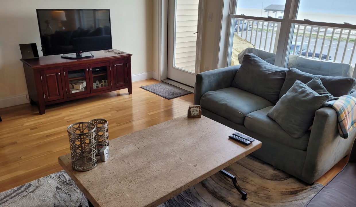 a living room filled with furniture and a flat screen tv.