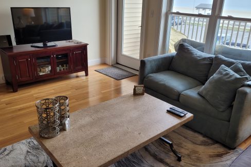 a living room filled with furniture and a flat screen tv.