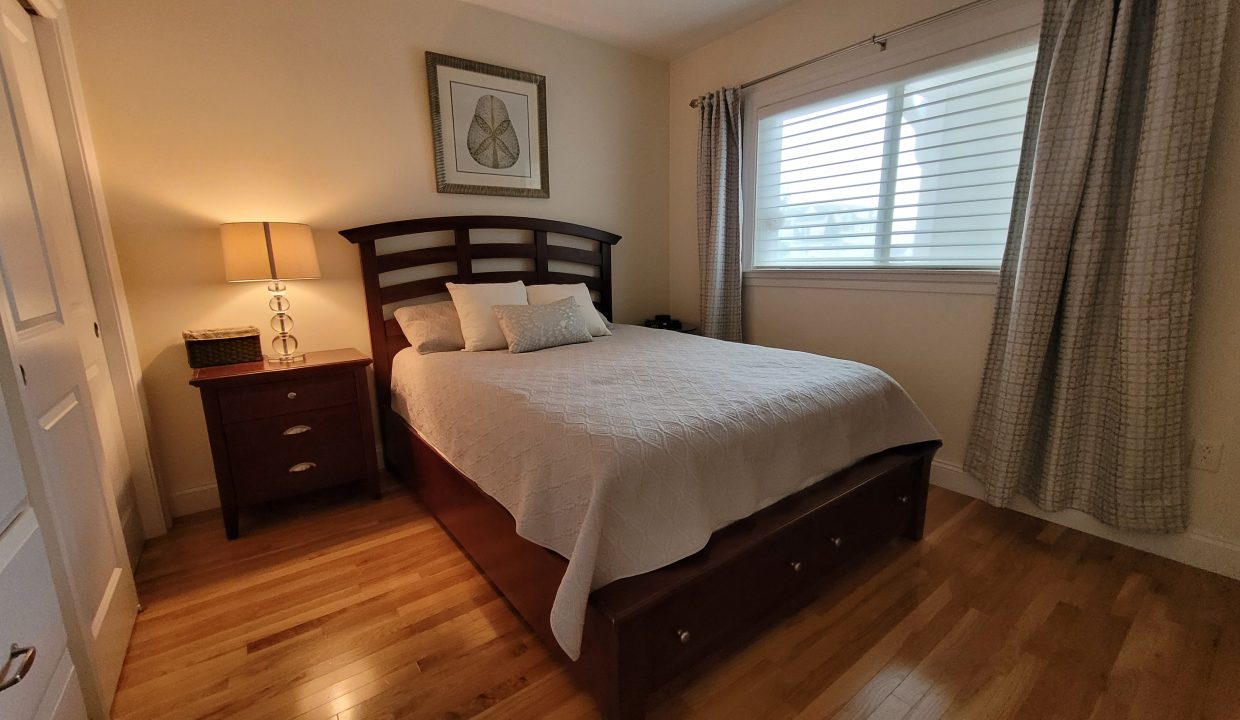 a bed sitting in a bedroom next to a window.