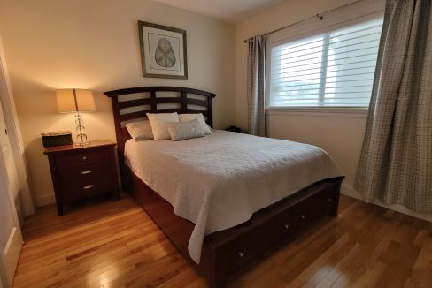 a bed sitting in a bedroom next to a window.