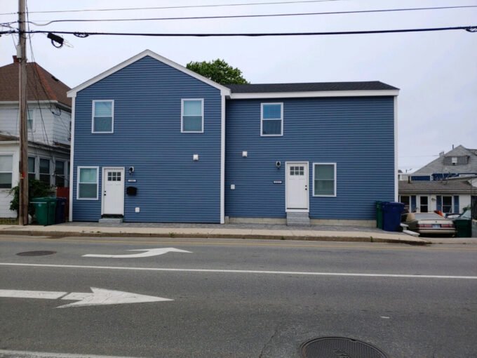 a blue building with a white door and windows.