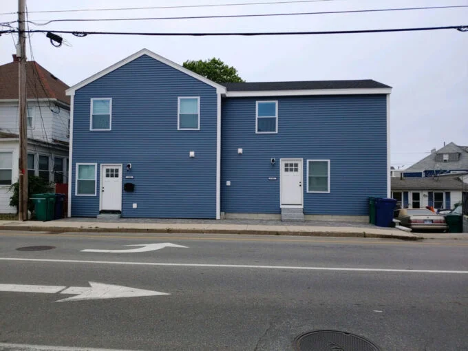 a blue building with a white door and windows.