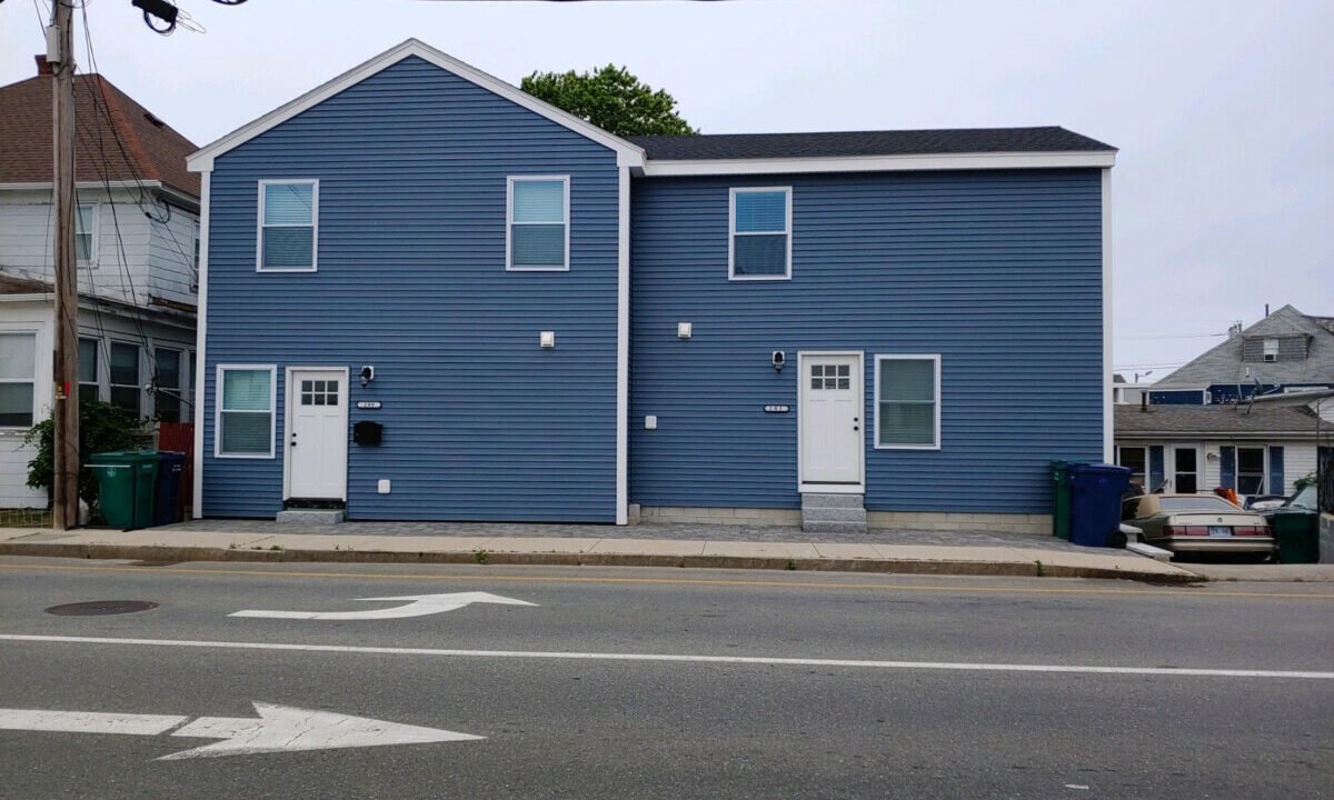 a blue building with a white door and windows.