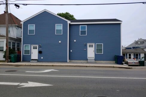 a blue building with a white door and windows.