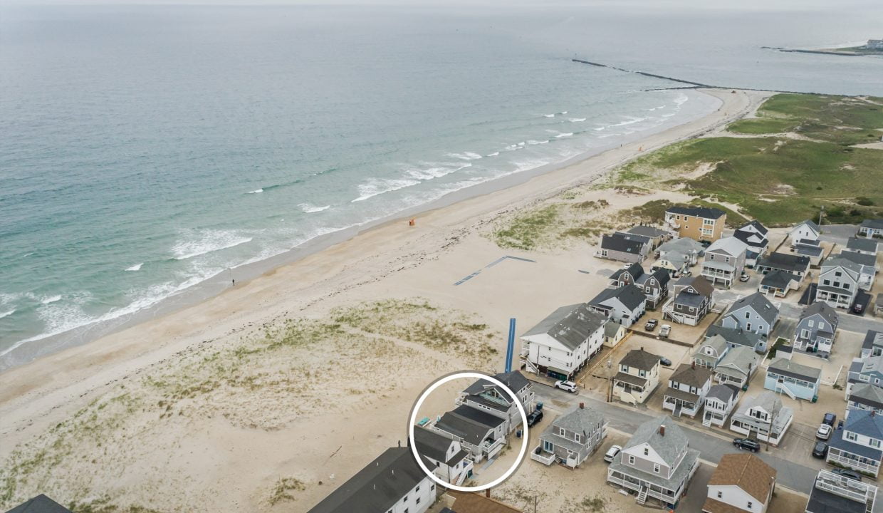 a bird's eye view of a beach and houses.