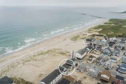 a bird's eye view of a beach and houses.