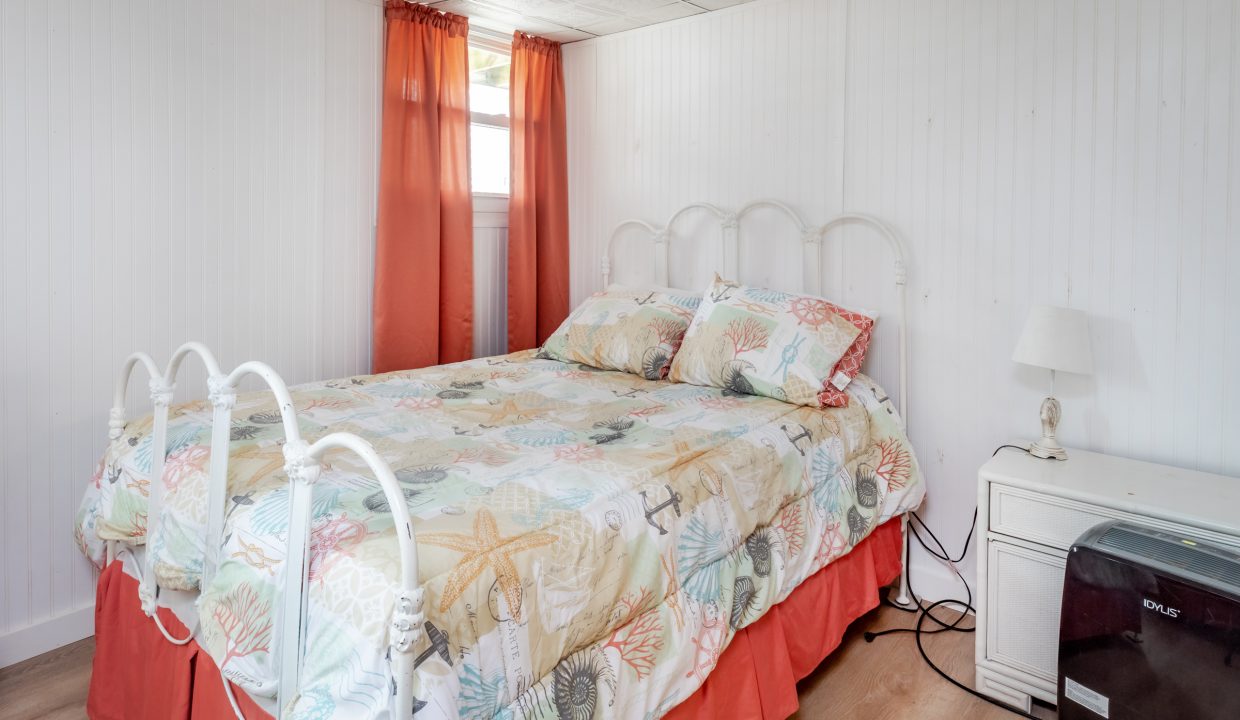 a bed sitting in a bedroom next to a window.