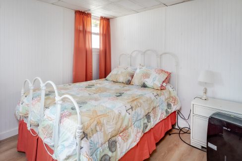 a bed sitting in a bedroom next to a window.