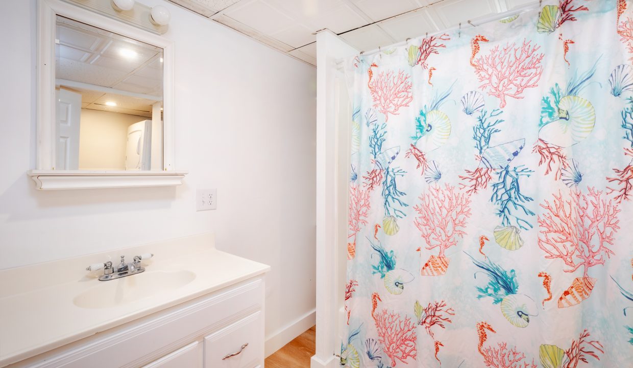 a bathroom with a shower curtain and a sink.