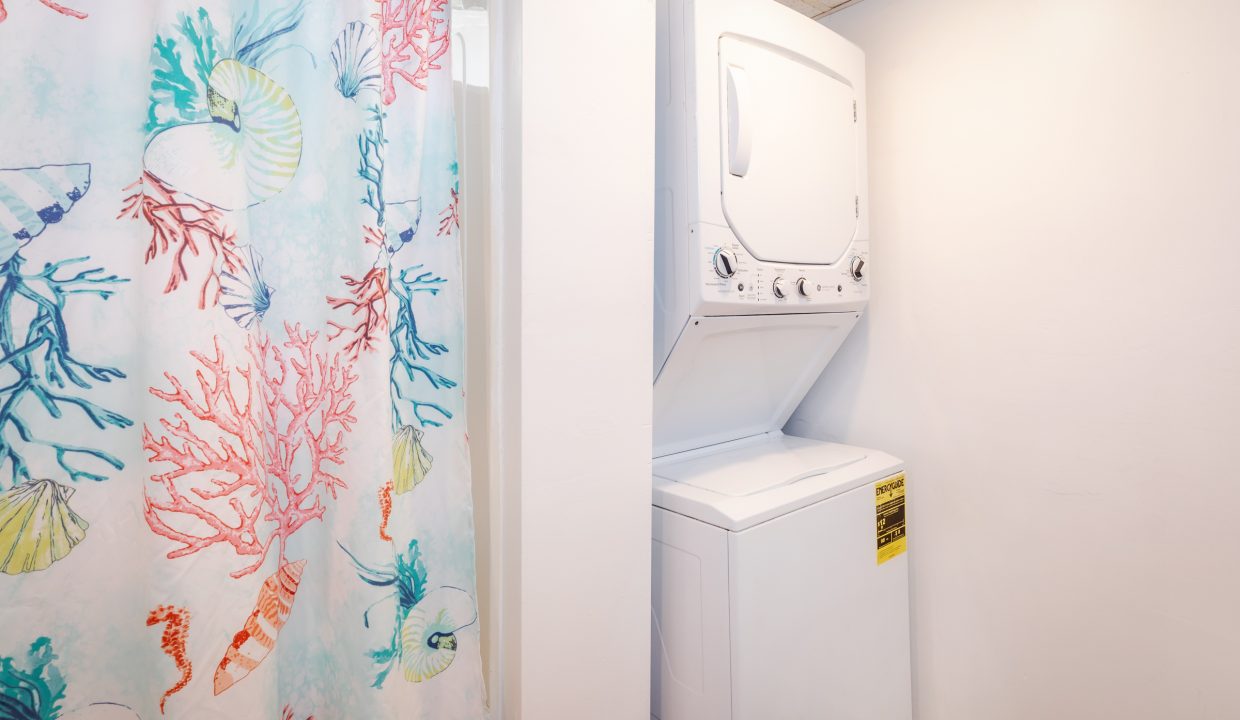 a washer and dryer in a small bathroom.