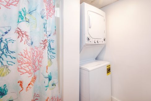 a washer and dryer in a small bathroom.