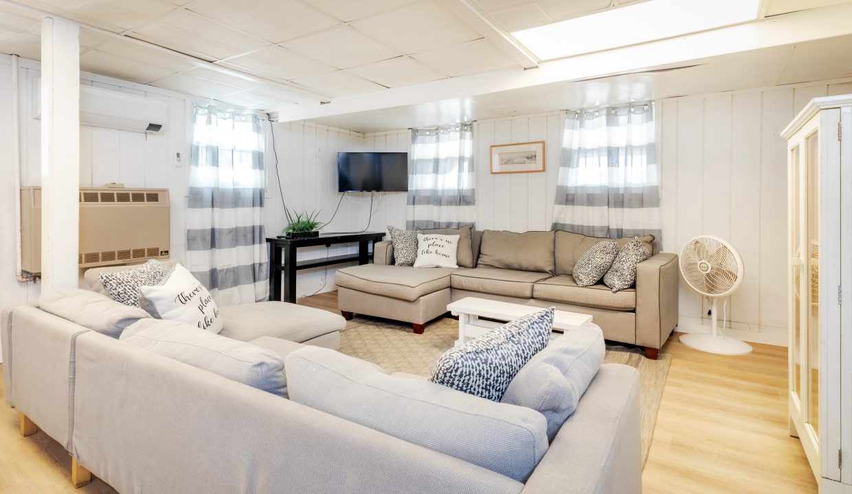 a living room filled with furniture and a flat screen tv.