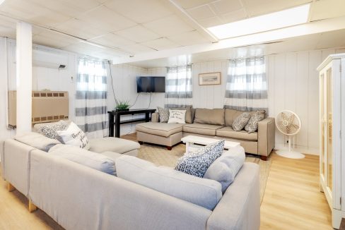 a living room filled with furniture and a flat screen tv.