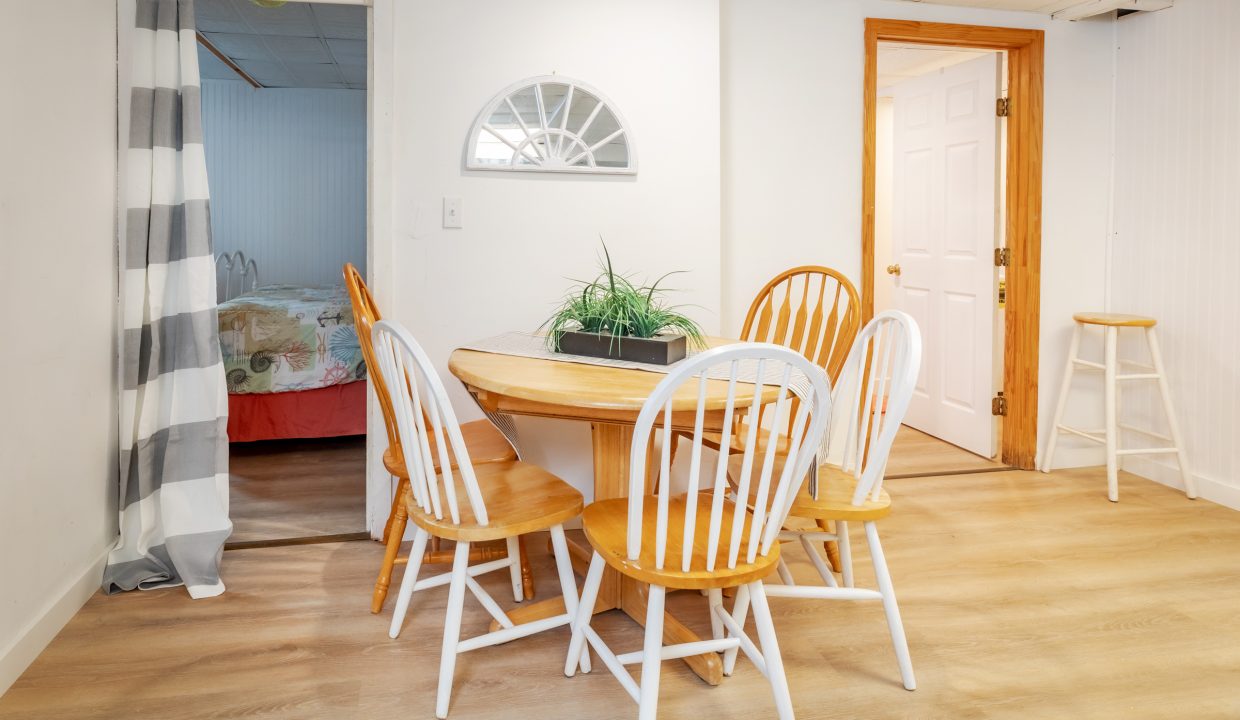 a dining room with a table and chairs.