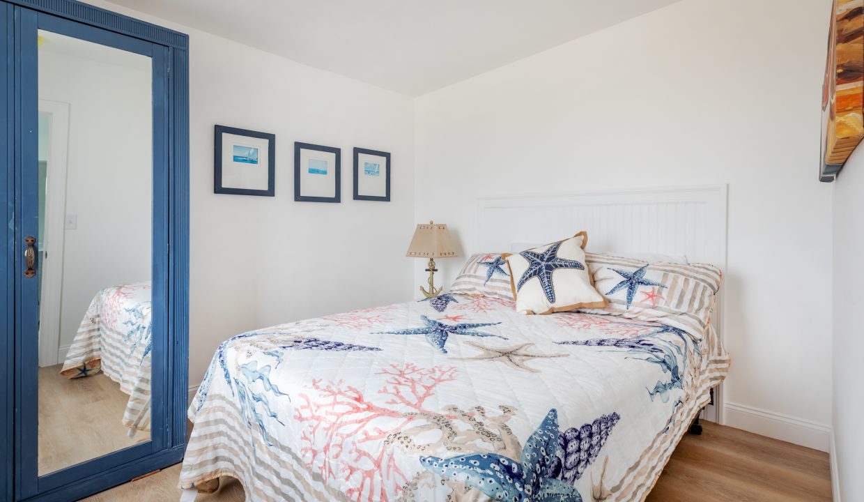 a bed sitting in a bedroom next to a blue door.