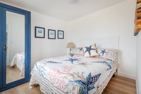 a bed sitting in a bedroom next to a blue door.