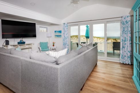 a living room filled with furniture and a flat screen tv.