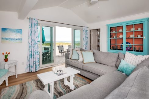 a living room filled with furniture and a sliding glass door.