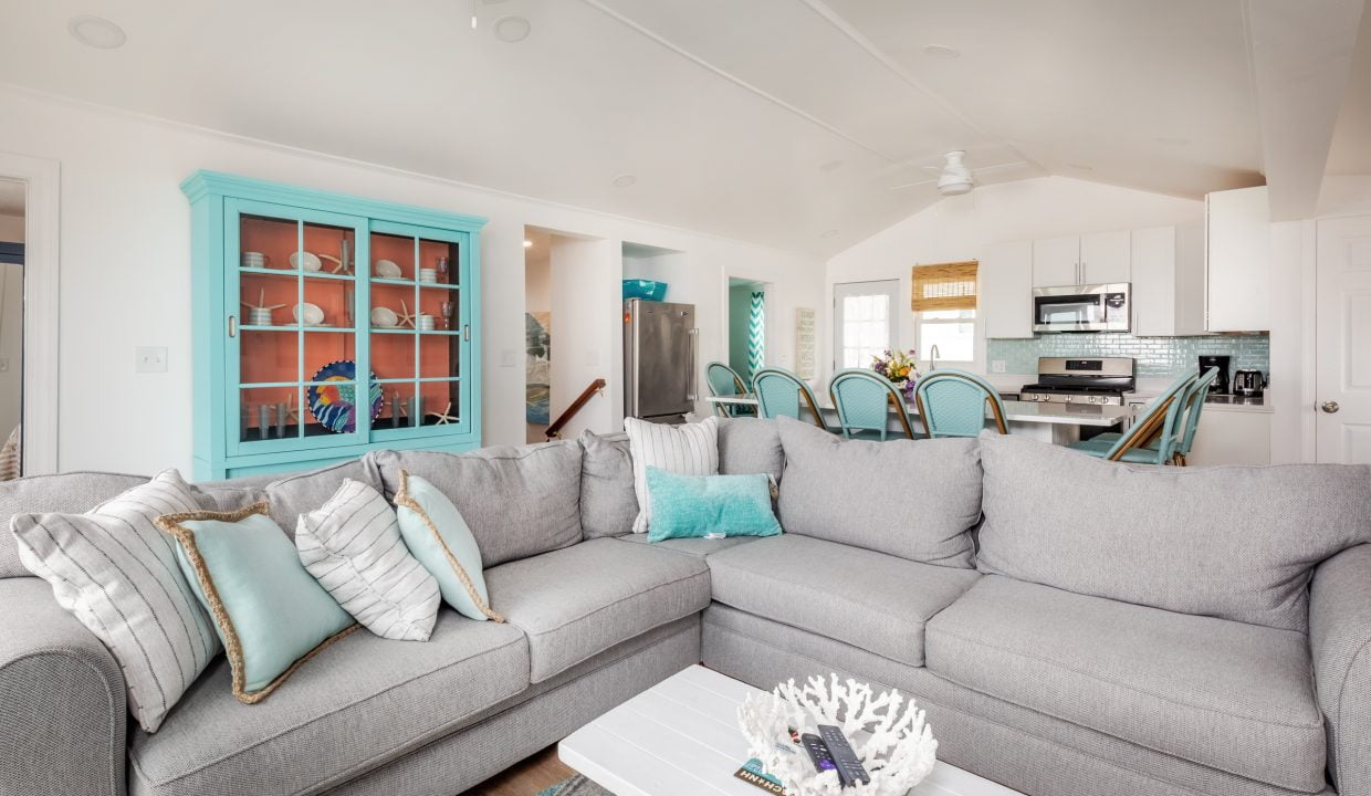 a living room filled with furniture and a large window.