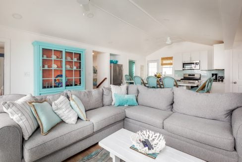 a living room filled with furniture and a large window.