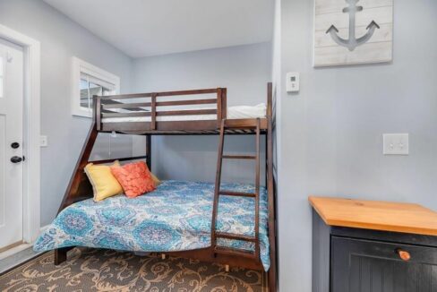 a bedroom with a bunk bed and a dresser.