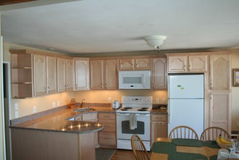 a kitchen with a white stove top oven.