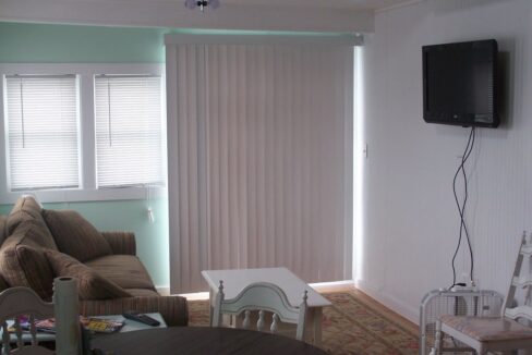 a living room filled with furniture and a flat screen tv.