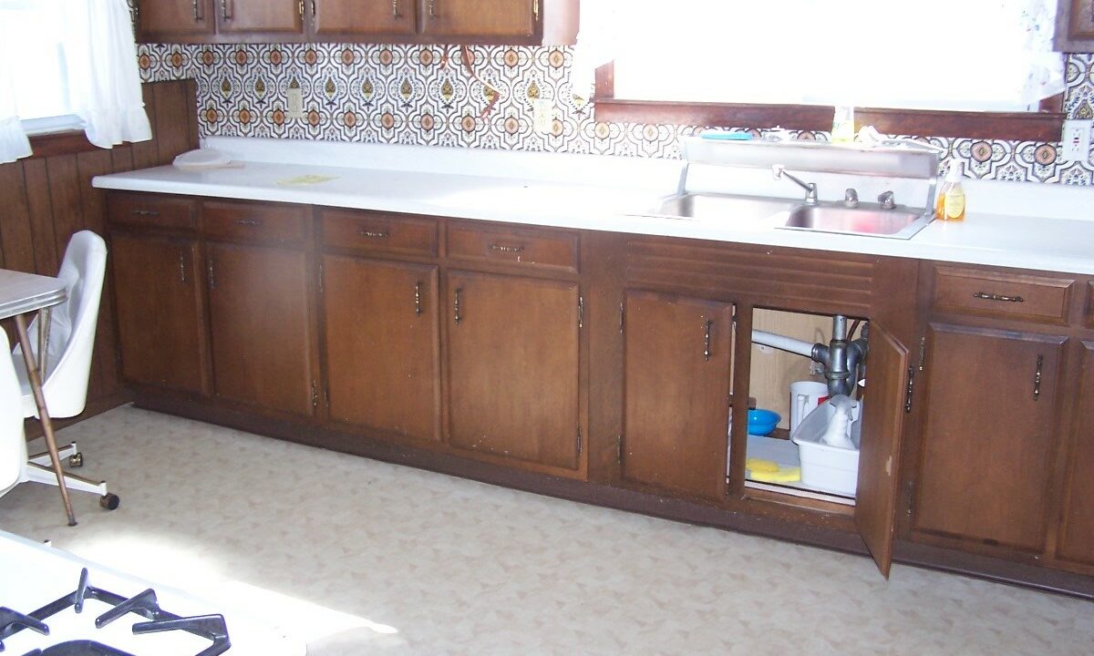 a kitchen with wooden cabinets and a stove top oven.