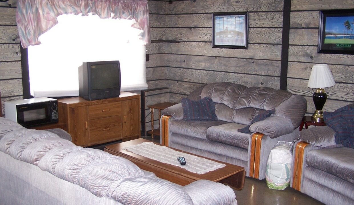 a living room filled with furniture and a flat screen tv.