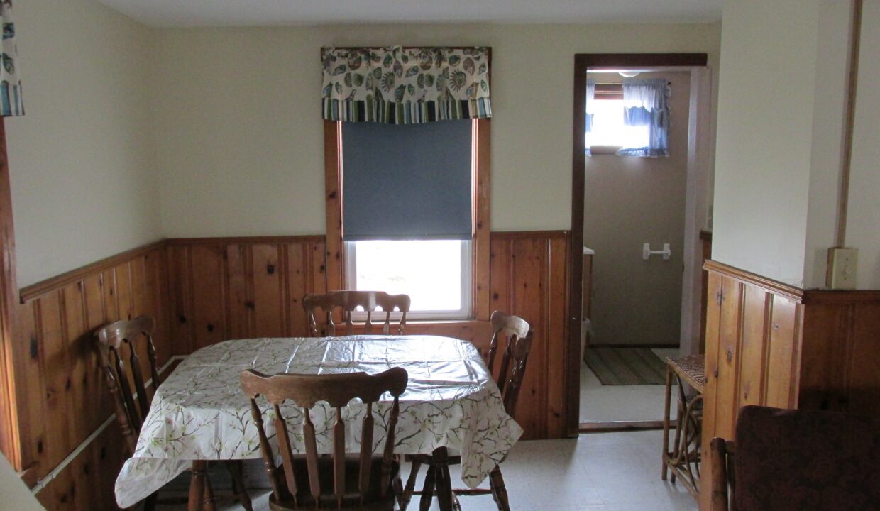 a dining room with a table and chairs.