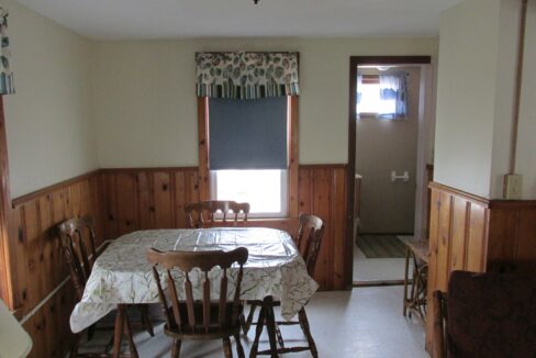 a dining room with a table and chairs.