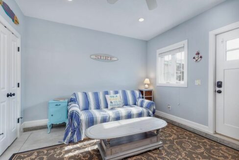 a blue and white striped couch in a room.