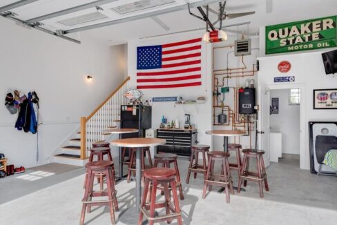 a room filled with lots of furniture and a flag hanging on the wall.