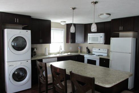 a kitchen with a washer and dryer in it.
