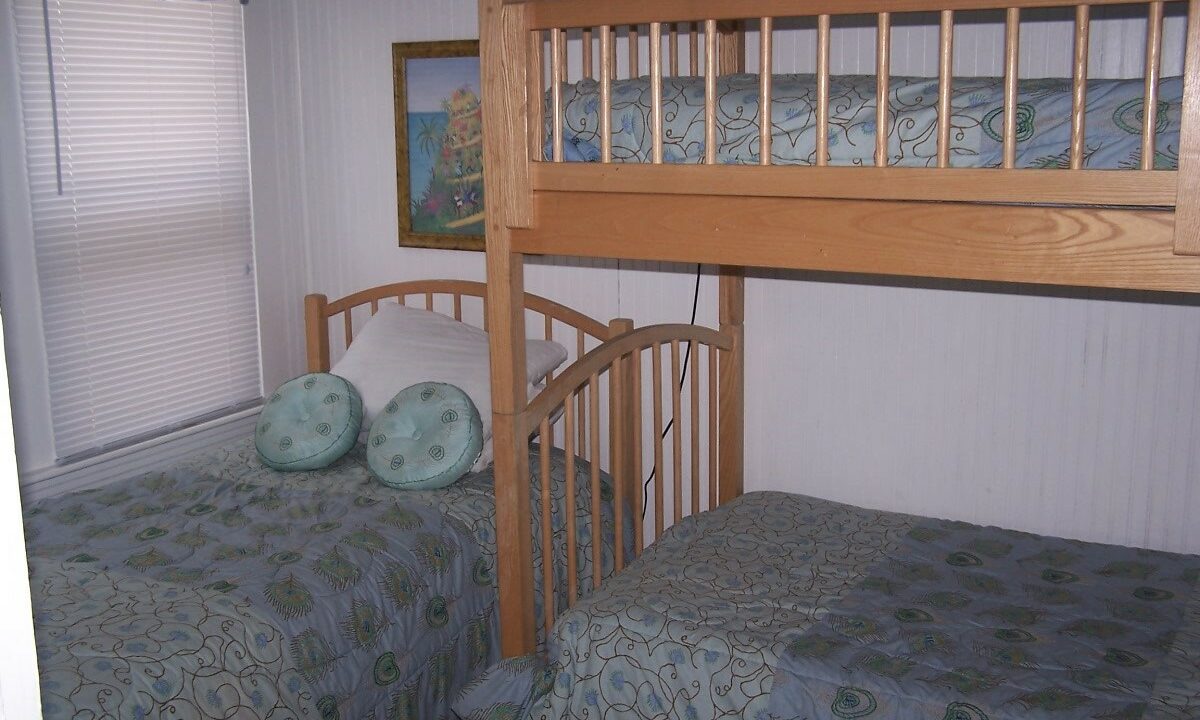 a bunk bed with two beds underneath it.