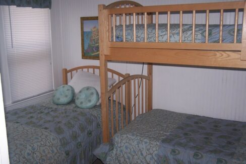 a bunk bed with two beds underneath it.