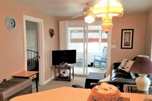 a living room filled with furniture and a flat screen tv.