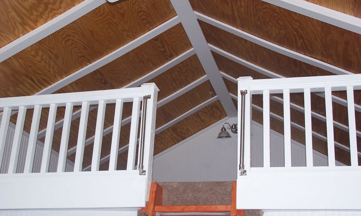 a loft with a ladder leading up to a loft.