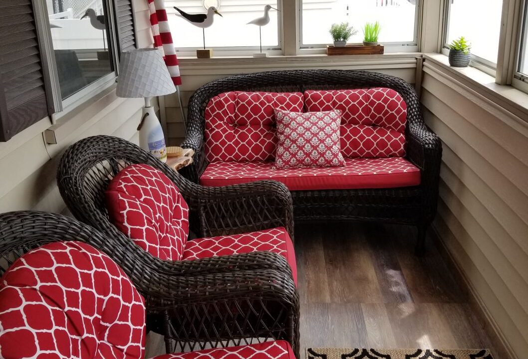 a living room with red and black furniture.