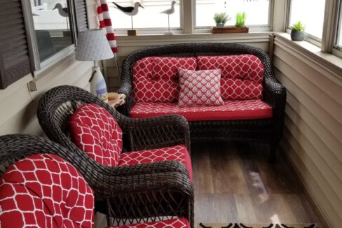 a living room with red and black furniture.