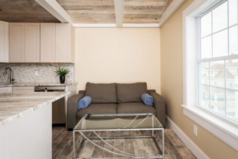 a living room with a couch a table and a window.